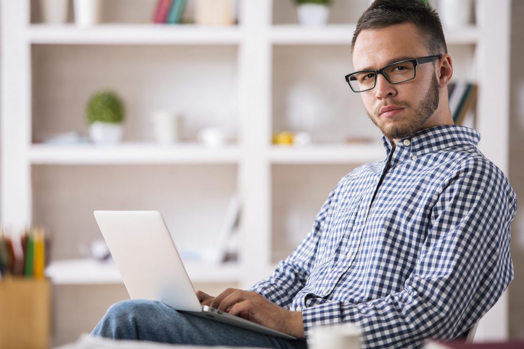 Caucasian male using laptop